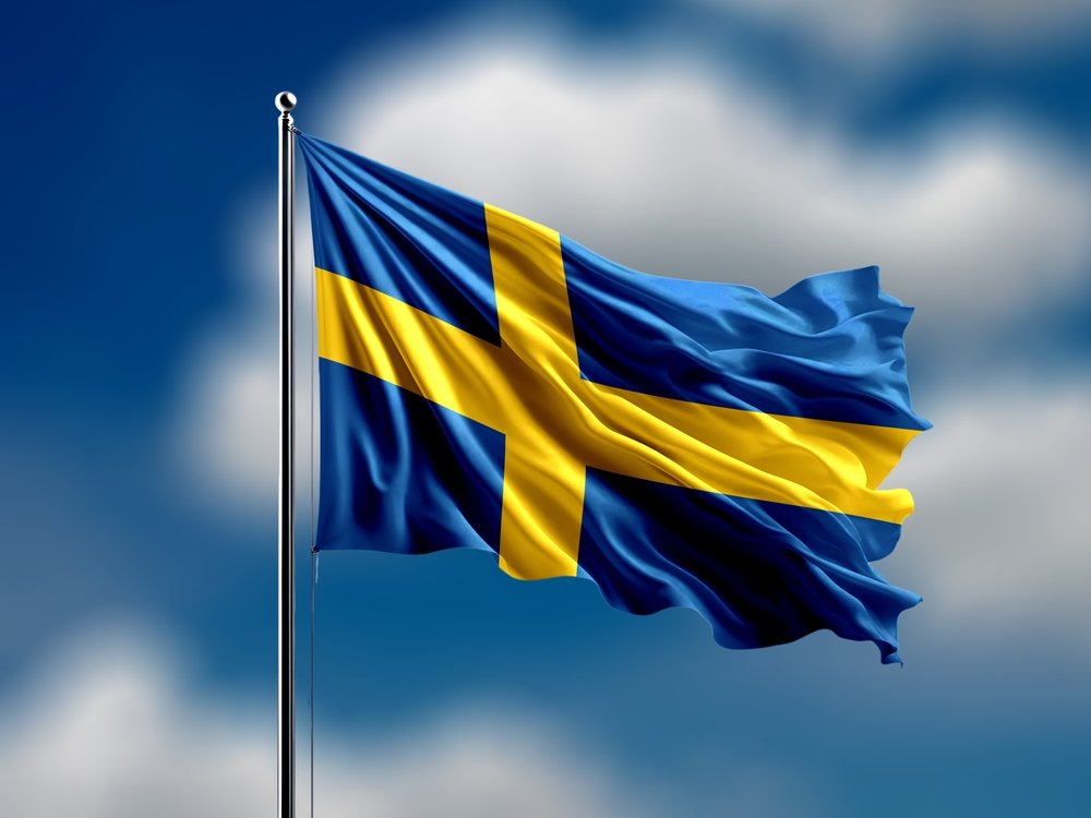 Sweden,Flag,Flying,On,Blur,Blue,Clouds,Background.